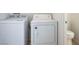 Convenient laundry room with modern washer and dryer, plus a nearby toilet at 6476 Ness Gardens Ct, Las Vegas, NV 89122