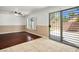 Bright living room with ceiling fan, wood floors, and sliding door access to backyard at 6476 Ness Gardens Ct, Las Vegas, NV 89122