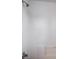 A clean shower with white tiles, a built-in seat, and modern fixtures for a minimalist aesthetic at 6476 Ness Gardens Ct, Las Vegas, NV 89122