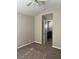 Bedroom with carpeted floor, ceiling fan, and doorway leading into a bathroom at 6532 Moon Roses Ct, Las Vegas, NV 89108