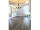 Bright, open-concept living room with elegant chandelier, fireplace, and attractive laminate flooring at 6532 Moon Roses Ct, Las Vegas, NV 89108