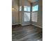 Entryway featuring high ceilings, multiple windows, and attractive laminate flooring at 6532 Moon Roses Ct, Las Vegas, NV 89108