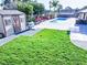 Lush backyard with green grass, pool, hot tub, gazebo, and storage shed at 6540 Tara Ave, Las Vegas, NV 89146