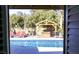 Inviting backyard showcases a sparkling pool, relaxing hot tub, covered seating area, and lush greenery at 6540 Tara Ave, Las Vegas, NV 89146
