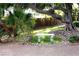 Backyard bench seating beneath a mature shady tree and desert landscaping at 6540 Tara Ave, Las Vegas, NV 89146