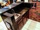 Indoor bar area with black countertop, sink, and tile flooring provides space for entertaining at 6540 Tara Ave, Las Vegas, NV 89146
