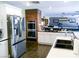 Bright, modern kitchen boasts white cabinetry, an island sink, stainless steel appliances, and a brick accent wall at 6540 Tara Ave, Las Vegas, NV 89146