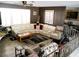 Spacious living room with a sectional sofa, tile flooring, and comfortable seating arrangement at 6540 Tara Ave, Las Vegas, NV 89146