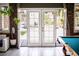 Double doors lead to the backyard and connect to the living space with a pool table at 6540 Tara Ave, Las Vegas, NV 89146