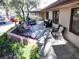 Covered patio with multiple seating areas, desert landscaping, and mature trees at 6540 Tara Ave, Las Vegas, NV 89146