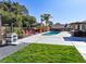 Inviting pool area with a hot tub gazebo, lush landscaping, outdoor shower, and a built-in barbecue at 6540 Tara Ave, Las Vegas, NV 89146