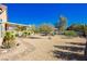 Expansive backyard with desert landscaping, covered patio, and ample space for outdoor activities at 6617 Golden Bit Ave, Las Vegas, NV 89131
