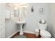 Half bathroom featuring pedestal sink, wood-look floors, and neutral paint at 6617 Golden Bit Ave, Las Vegas, NV 89131