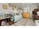 Bright bedroom features wood-look flooring, charming decor, and a cozy daybed with throw pillows at 6617 Golden Bit Ave, Las Vegas, NV 89131