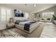 Staged bedroom featuring a sitting area, and natural light from the shuttered windows at 6617 Golden Bit Ave, Las Vegas, NV 89131