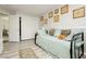 Neutral bedroom with light wood-look floors, daybed, and closet with mirrored sliding doors at 6617 Golden Bit Ave, Las Vegas, NV 89131