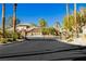 Gated community entrance featuring lush landscaping and secure access, ensuring privacy and exclusivity for residents at 6617 Golden Bit Ave, Las Vegas, NV 89131
