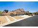 Spacious single-story home with a three-car garage and RV parking, showcasing desert landscaping and curb appeal at 6617 Golden Bit Ave, Las Vegas, NV 89131