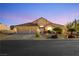 Home exterior showcasing a three-car garage, tile roof, desert landscaping and paved driveway at 6617 Golden Bit Ave, Las Vegas, NV 89131
