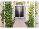 Elegant double front doors framed by lush greenery, creating a welcoming entrance to the home at 6617 Golden Bit Ave, Las Vegas, NV 89131