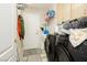 Functional laundry room with modern black appliances, storage cabinets, and direct access to the exterior at 6617 Golden Bit Ave, Las Vegas, NV 89131