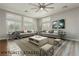 Staged living room showcasing neutral walls, hardwood floors and oversized windows with shutters at 6617 Golden Bit Ave, Las Vegas, NV 89131