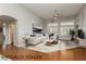 Open living room features a vaulted ceiling, ceiling fan, and decorative window shutters at 6617 Golden Bit Ave, Las Vegas, NV 89131