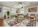 Bright living room with large windows, modern ceiling fan, and stylish decor at 6617 Golden Bit Ave, Las Vegas, NV 89131