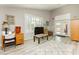 Bright living room featuring a white rug, desk, modern furniture, and a view of the backyard through French doors at 6617 Golden Bit Ave, Las Vegas, NV 89131