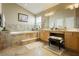Luxurious bathroom with a soaking tub, double vanity, and decorative tile accents for a relaxing spa experience at 6617 Golden Bit Ave, Las Vegas, NV 89131