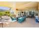 Inviting covered patio with comfortable seating, ceiling fan, and outdoor dining area at 6617 Golden Bit Ave, Las Vegas, NV 89131