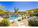 Sparkling backyard pool and spa surrounded by lush landscaping and a paver walkway at 6617 Golden Bit Ave, Las Vegas, NV 89131