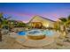 Outdoor pool and hot tub with desert landscaping, covered patio and dusk sky at 6617 Golden Bit Ave, Las Vegas, NV 89131