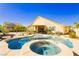 In-ground pool with spa surrounded by landscaped backyard and covered patio at 6617 Golden Bit Ave, Las Vegas, NV 89131