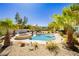 Inviting backyard pool area with surrounding landscaping and blue skies above at 6617 Golden Bit Ave, Las Vegas, NV 89131