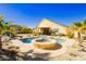 Landscaped backyard featuring in-ground pool with spa and covered patio at 6617 Golden Bit Ave, Las Vegas, NV 89131