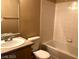 Cozy bathroom with tiled walls, standard tub, neutral countertop and white toilet at 6955 Durango Dr # 3092, Las Vegas, NV 89149