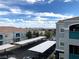 Elevated view of apartments showing parking areas, surrounding buildings and city lights in the distance at 6955 Durango Dr # 3092, Las Vegas, NV 89149