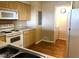 Functional kitchen featuring white appliances, light wood cabinets, and laminate countertops at 6955 Durango Dr # 3092, Las Vegas, NV 89149