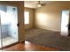 Bright and airy living room with carpet and tile flooring, leading to a balcony and an open doorway at 6955 Durango Dr # 3092, Las Vegas, NV 89149