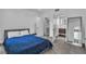 Relaxing bedroom with a blue duvet, tile floors, and an open walk-in closet and bathroom for convenience and comfort at 6955 N Durango Dr # 1074, Las Vegas, NV 89149