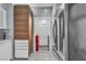 Hallway view into in-unit laundry space with side-by-side washer and dryer and view to kitchen at 6955 N Durango Dr # 1074, Las Vegas, NV 89149