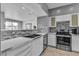 Modern kitchen with white countertops, stainless steel appliances, and a breakfast bar overlooking the living area at 6955 N Durango Dr # 1074, Las Vegas, NV 89149
