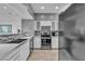 Updated kitchen featuring stainless steel appliances, mosaic backsplash, and ample counter space for cooking at 6955 N Durango Dr # 1074, Las Vegas, NV 89149