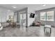 Open-concept living room featuring a dining area, modern decor, and a mirrored wall at 6955 N Durango Dr # 1074, Las Vegas, NV 89149