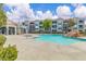 Resort-style pool with mature shade tree and ample deck seating surrounded by the condo community at 6955 N Durango Dr # 1074, Las Vegas, NV 89149