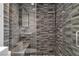 Contemporary shower with stylish gray tiles, recessed niche, and dual shower heads, offering a spa-like experience at 6955 N Durango Dr # 1074, Las Vegas, NV 89149