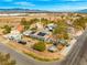 An aerial view of a property with solar panels, mature trees, outbuildings and recreational vehicles at 6995 Rogers St, Las Vegas, NV 89118