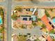 Aerial view featuring a home with solar panels, outbuildings, RV parking, pool and mature trees at 6995 Rogers St, Las Vegas, NV 89118
