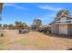 The expansive backyard features gravel, a playground, an outbuilding, and plenty of room for activities at 6995 Rogers St, Las Vegas, NV 89118